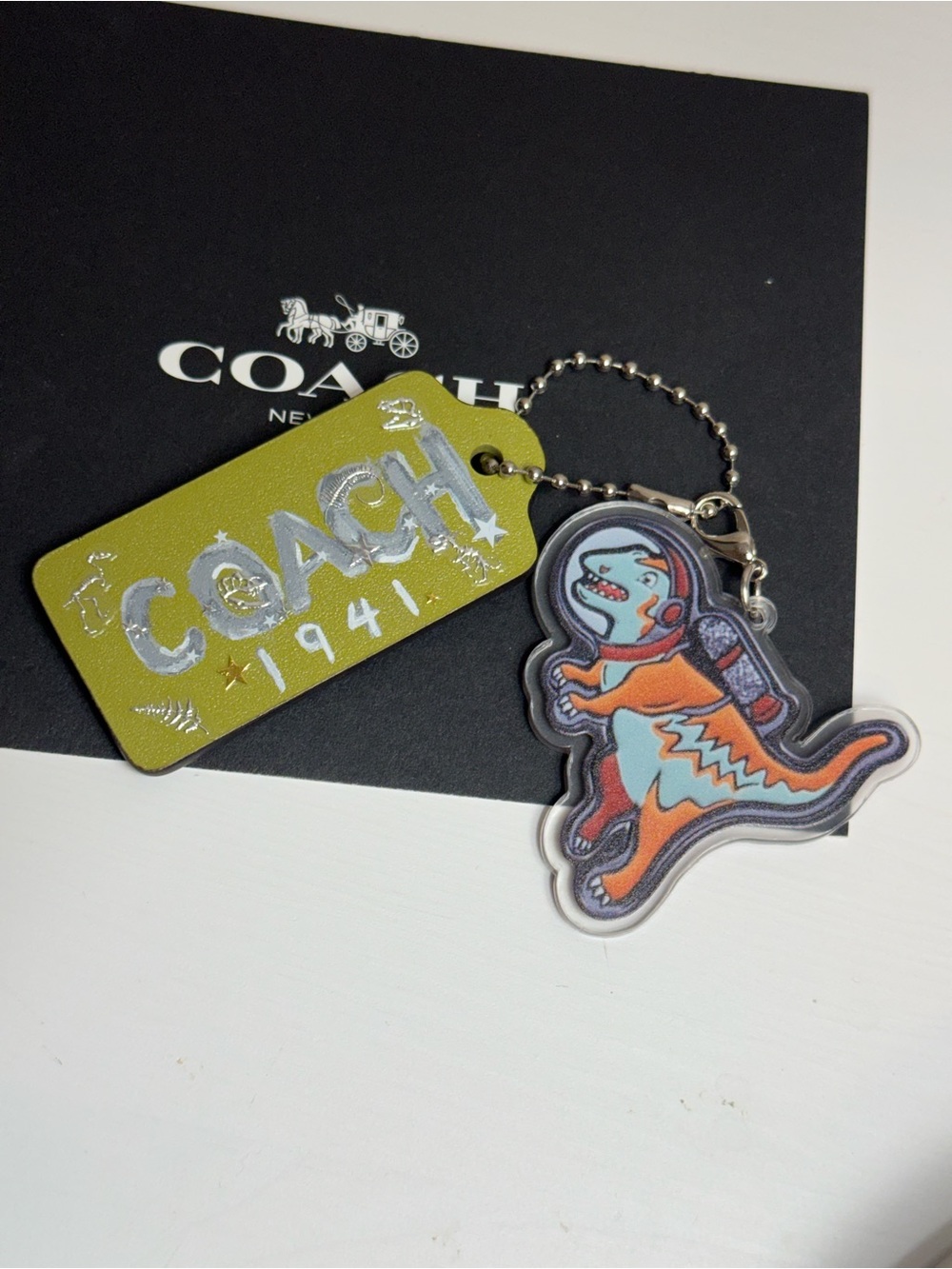 Coach green tag with skeleton dinosaur and rexy charm